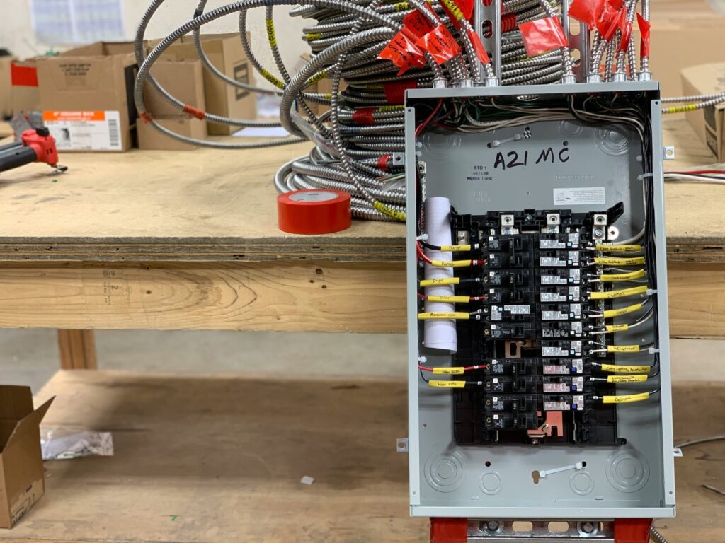 Electrician wiring a residential electrical panel for an EV charger circuit